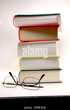 Pile of books and reading glasses Stock Photo