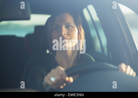 Young businesswoman driving car Stock Photo