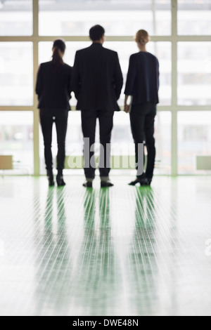 Rear view of business people standing in office Stock Photo