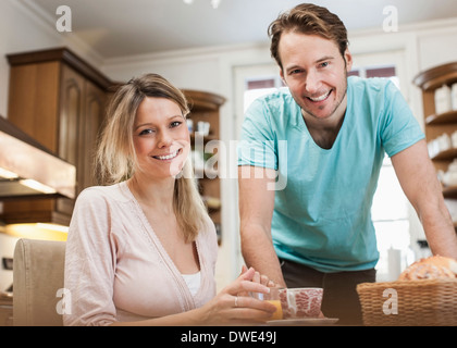 Portrait of happy mid adult couple in kitchen Stock Photo