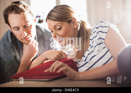 Mid adult couple using digital tablet in house Stock Photo