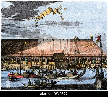 Market in Batavia (now Jakarta) in the 1600s, when Java was a Dutch colony. Hand-colored print Stock Photo