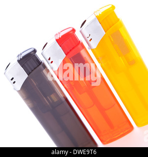 Row of vividly coloured plastic disposable lighters for smokers in red, yellow, two shades of blue and black isolated on a white background Stock Photo