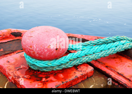 Sea concept : red mooring bollard for very large boat over ocean Stock Photo