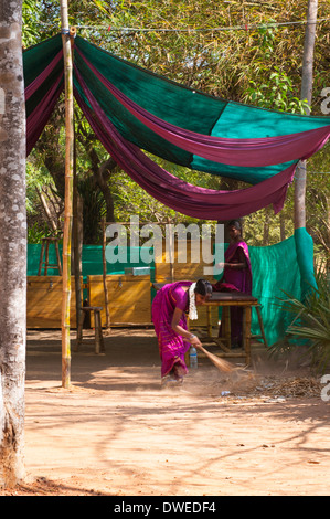 India Tamil Nadu Pondicherry Puducherry Auroville Matri Mandir meditation spiritual centre center park gardens tented area woman lady sweeping Stock Photo