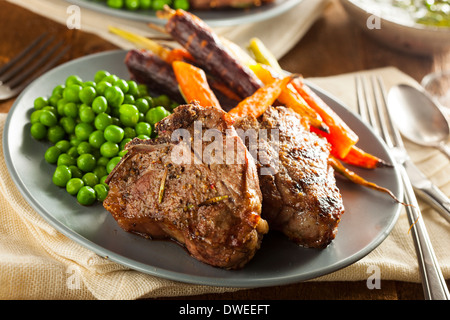 Homemade Cooked Lamb Chops with Peas and Carrots Stock Photo