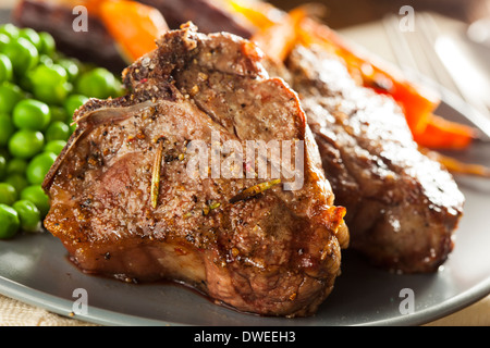 Homemade Cooked Lamb Chops with Peas and Carrots Stock Photo