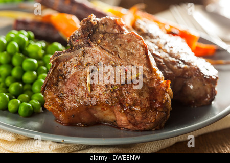 Homemade Cooked Lamb Chops with Peas and Carrots Stock Photo