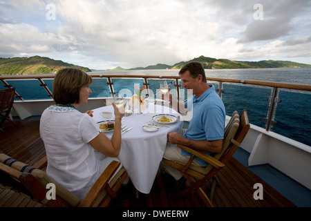 Diners at Delphinus Outdoor Cafe onboard the Aussie expedition cruiser Orion during the Melanesia & Solomon Islands cruise Stock Photo