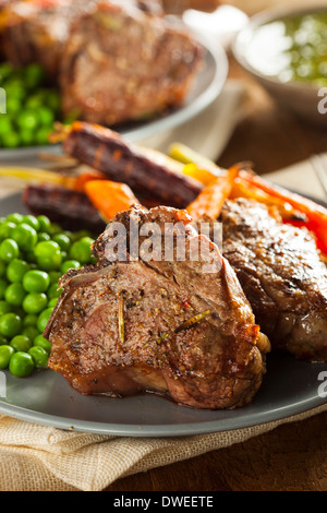 Homemade Cooked Lamb Chops with Peas and Carrots Stock Photo