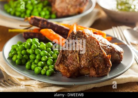 Homemade Cooked Lamb Chops with Peas and Carrots Stock Photo