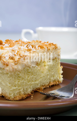 sponge cake with butter cream on a ceramic plate Stock Photo