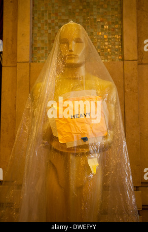 Oscar statue near Kodak Theater, protected with plastic from the rain, several days before the Academy Awards in 2014 Stock Photo