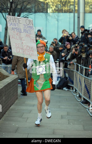 London, UK. 6th March 2014. Neil Horan also known as the Dancing Priest or the Grand Prix Priest dances a jig to music from his ghetto blaster to take advantage of the press assembled for the trial of Max Clifford at Southwark Crown Court on 11 charges of indecent assault.  London 06/03/2014 Credit:  JOHNNY ARMSTEAD/Alamy Live News Stock Photo