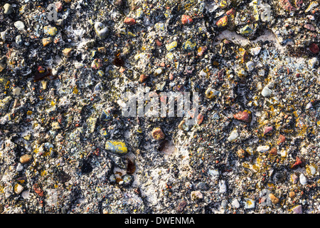 Background of a concrete wall with colored stones Stock Photo