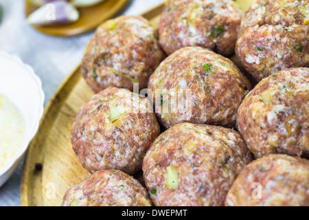 Raw meat balls of minced beef prepared for roll in breadcrumbs