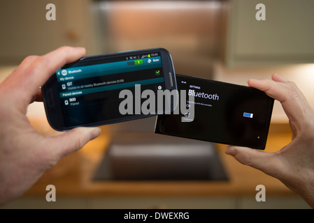 Two untethered smartphones communicating via Bluetooth technology Stock Photo