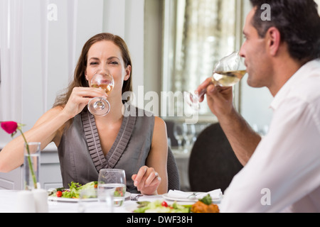 Couple drinking wine at dining table in restaurant Stock Photo