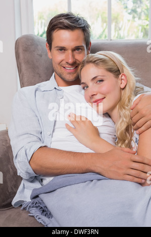 Portrait of a relaxed loving couple lying on sofa Stock Photo