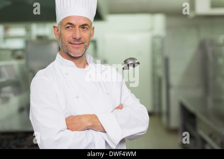 Confident chef with arms crossed holding a ladle Stock Photo