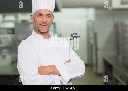 Confident chef with arms crossed holding a ladle Stock Photo