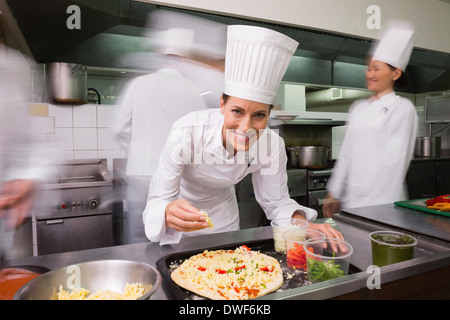 Happy chef preparing a pizza Stock Photo