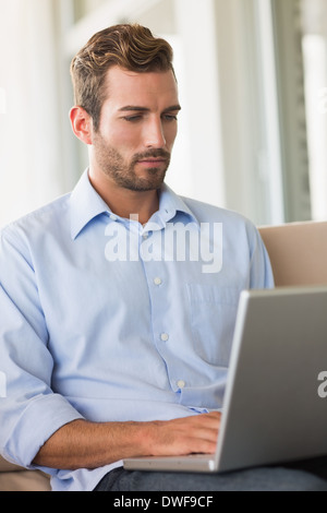 Handsome businessman working on laptop Stock Photo