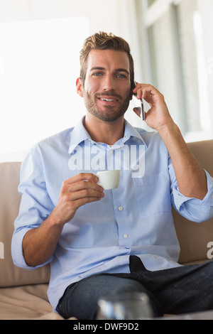 Handsome businessman on a phone call and drinking espresso Stock Photo