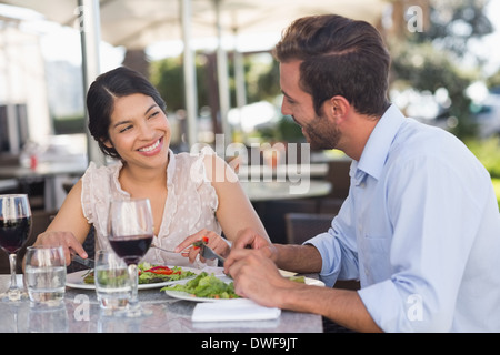 Happy couple on a date having lunch Stock Photo