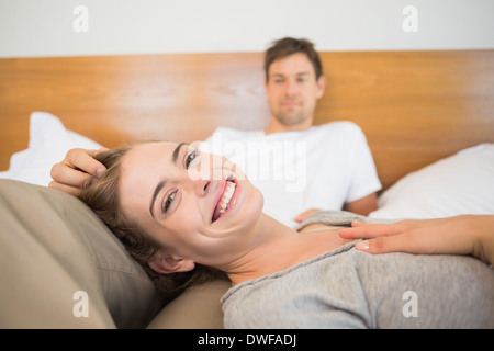 Happy couple relaxing on bed Stock Photo