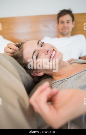 Happy couple relaxing on bed Stock Photo