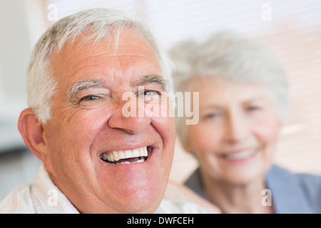 Smiling senior couple sitting on the couch Stock Photo