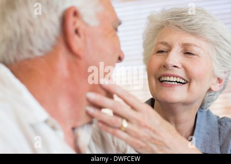 Smiling senior couple sitting on the couch Stock Photo