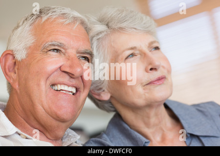 Smiling senior couple sitting on the couch Stock Photo