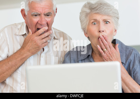 Shocked senior couple using the laptop Stock Photo