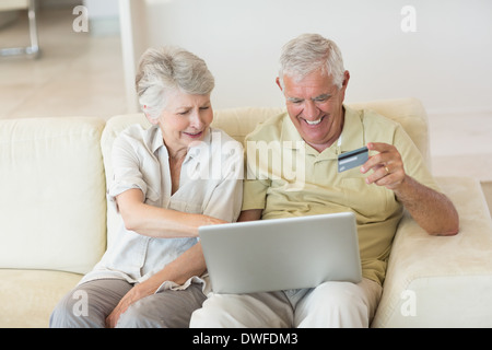 Senior couple using the laptop together to shop online Stock Photo