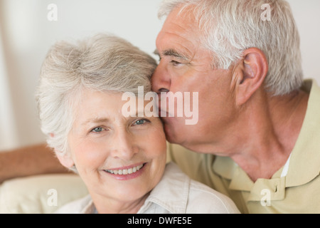 Cheerful senior couple relaxing on the couch together Stock Photo