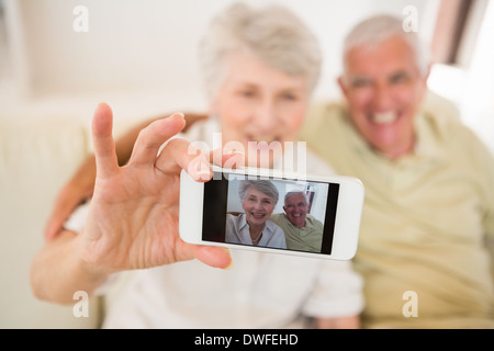Senior woman taking a selfie with her smartphone Stock Photo