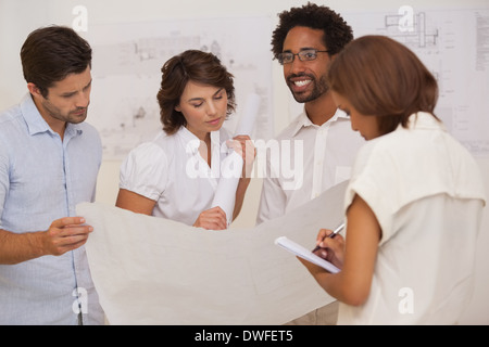 Group of architects working on blueprints Stock Photo