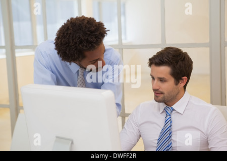 Businessmen working on computer in office Stock Photo