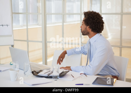 Serious businessman sitting at office desk Stock Photo
