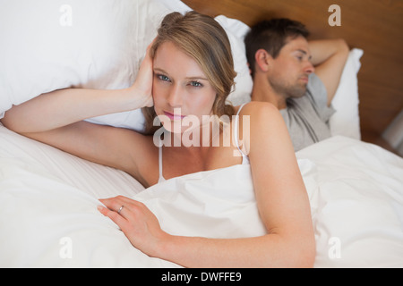 Couple not talking after an argument in bed Stock Photo