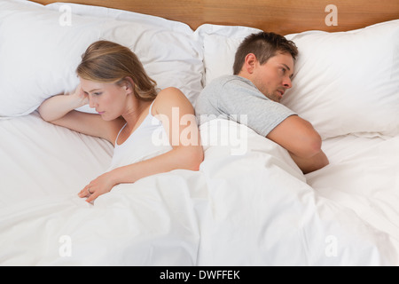 Couple not talking after an argument in bed Stock Photo