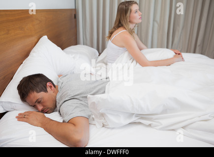 Couple not talking after an argument in bed Stock Photo