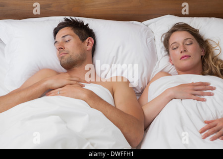 Young couple sleeping in bed Stock Photo