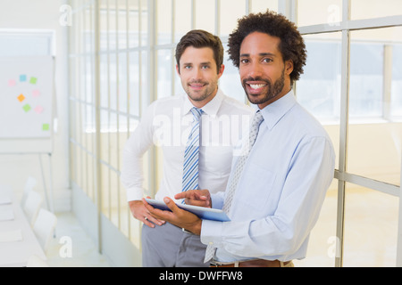 Two businessmen with digital tablet in office Stock Photo