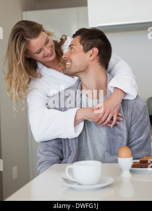 Loving couple looking at each other in kitchen Stock Photo