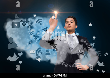 Asian businessman pointing to light above app cloud Stock Photo