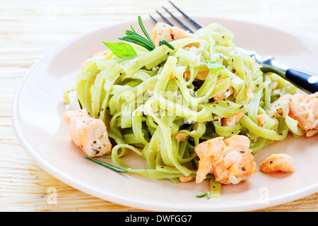 pasta with spinach and salmon, food closeup Stock Photo