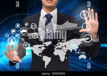 Businessman touching earth interface with graphics Stock Photo